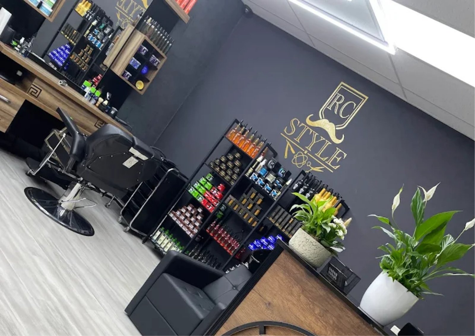 Interior view of RC Style barbershop in Kerkrade showcasing modern design and grooming product shelves
